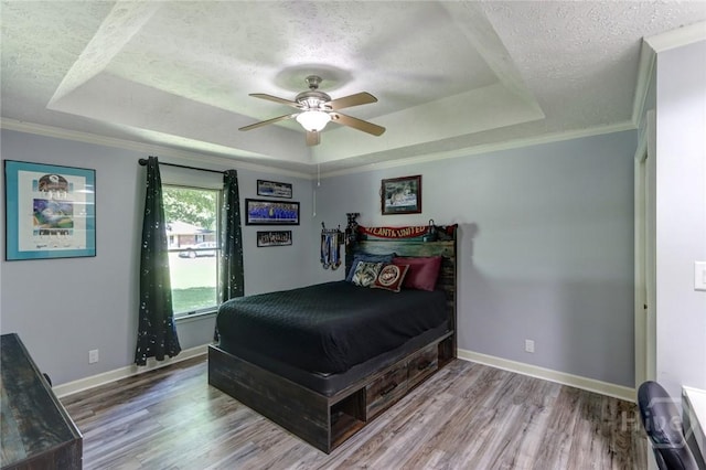 1333 La Vista Cir, Pooler, GA 31322 - bedroom with a tray ceiling, a textured ceiling, wood finished floors, ceiling fan, and ornamental molding