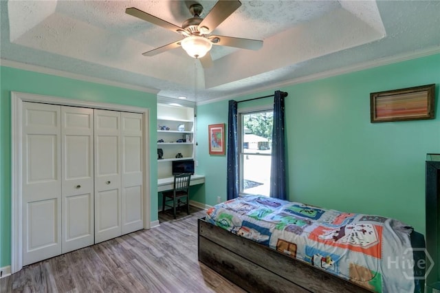1333 La Vista Cir, Pooler, GA 31322 - bedroom with crown molding, wood finished floors, a closet, a raised ceiling, and a textured ceiling
