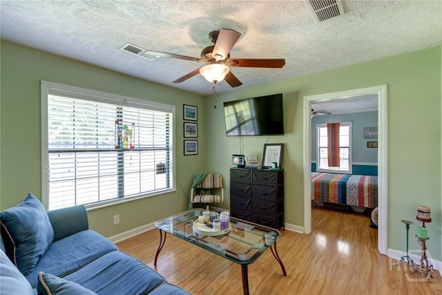 1333 La Vista Cir, Pooler, GA 31322 - living room featuring a ceiling fan, a textured ceiling, and light wood finished floors