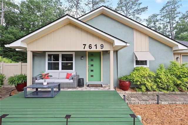 7619 Lynes Ct, Savannah, GA 31406 - view of front of house with stucco siding, a deck, and outdoor lounge area