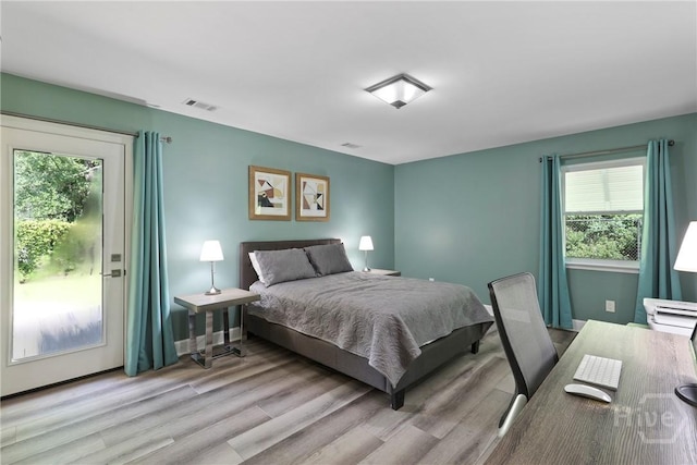 7619 Lynes Ct, Savannah, GA 31406 - bedroom featuring multiple windows, wood finished floors, and access to exterior