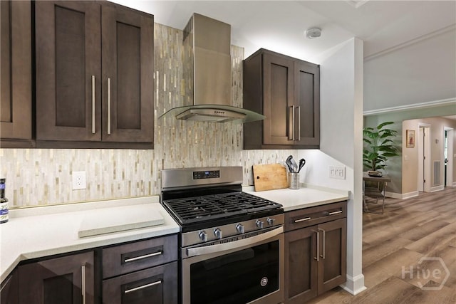 7619 Lynes Ct, Savannah, GA 31406 - kitchen with stainless steel gas range, wall chimney range hood, and dark brown cabinetry