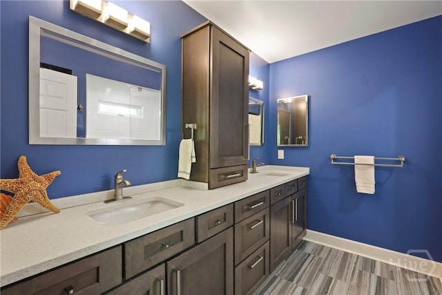 7619 Lynes Ct, Savannah, GA 31406 - bathroom featuring double vanity and baseboards