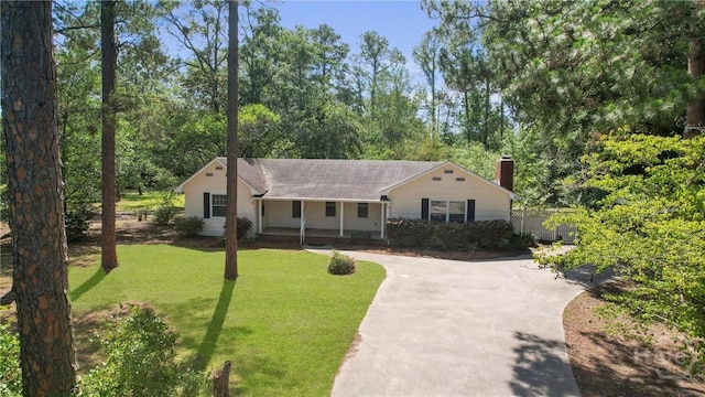 265 Mahan St, Jesup, GA 31545 - view of front of home featuring covered porch, a chimney, a front yard, driveway, and roof with shingles