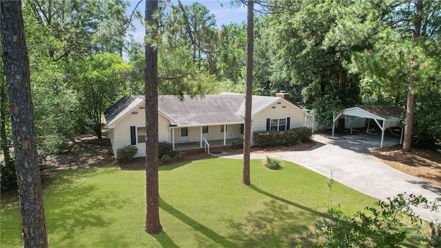 265 Mahan St, Jesup, GA 31545 - ranch-style house featuring a detached carport, a porch, concrete driveway, a front yard, and roof with shingles