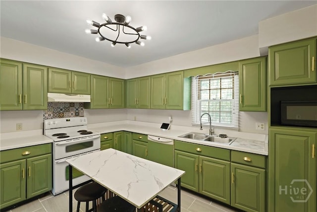 265 Mahan St, Jesup, GA 31545 - kitchen featuring under cabinet range hood, white appliances, light countertops, light tile patterned flooring, and tasteful backsplash