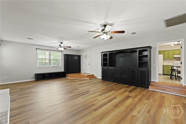 265 Mahan St, Jesup, GA 31545 - unfurnished living room featuring ceiling fan and light wood-style floors