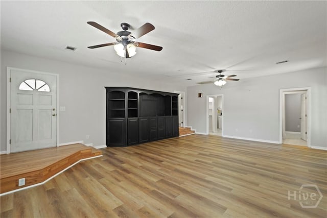265 Mahan St, Jesup, GA 31545 - unfurnished living room with a ceiling fan and light wood finished floors