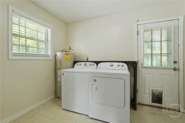 265 Mahan St, Jesup, GA 31545 - washroom featuring water heater, independent washer and dryer, healthy amount of natural light, and light tile patterned floors