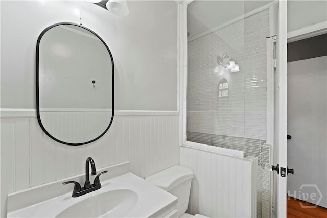 265 Mahan St, Jesup, GA 31545 - bathroom with a wainscoted wall and wood finished floors