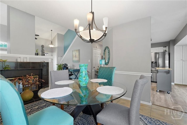 505 Pointe N Dr, Savannah, GA 31410 - dining area featuring a chandelier, light tile patterned floors, and vaulted ceiling