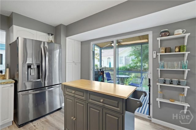 505 Pointe N Dr, Savannah, GA 31410 - kitchen with stainless steel fridge with ice dispenser, light wood-style floors, white cabinets, butcher block countertops, and a center island