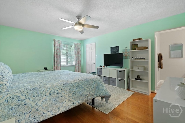 505 Pointe N Dr, Savannah, GA 31410 - bedroom with wood finished floors, a textured ceiling, a closet, and ceiling fan