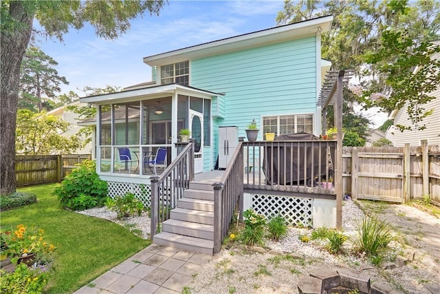 505 Pointe N Dr, Savannah, GA 31410 - rear view of house featuring a sunroom, a fenced backyard, and a wooden deck