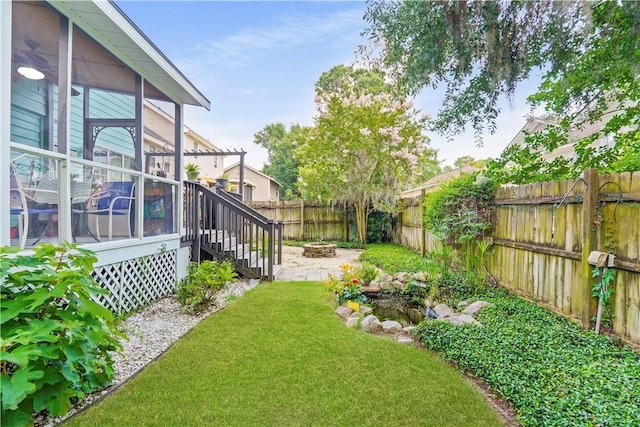 505 Pointe N Dr, Savannah, GA 31410 - fenced backyard with an outdoor fire pit, a sunroom, and a patio area
