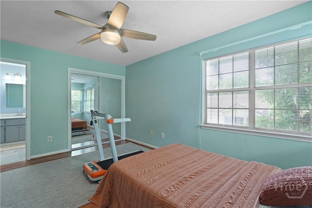 505 Pointe N Dr, Savannah, GA 31410 - bedroom with multiple windows, connected bathroom, a closet, ceiling fan, and a textured ceiling