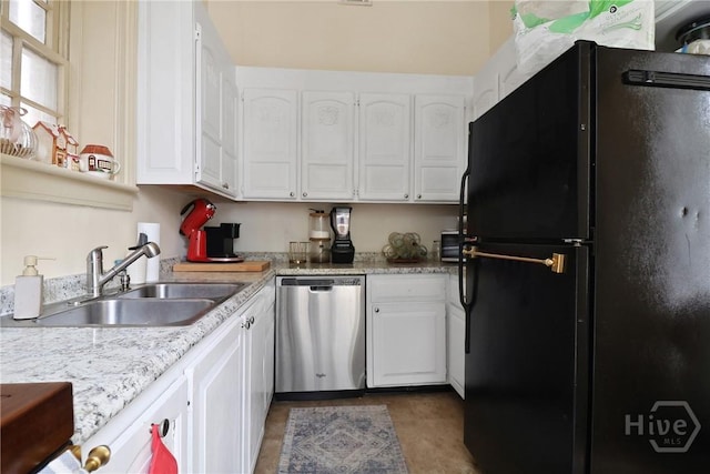24 E Jones St, Savannah, GA 31401 - kitchen with freestanding refrigerator, stainless steel dishwasher, and white cabinetry