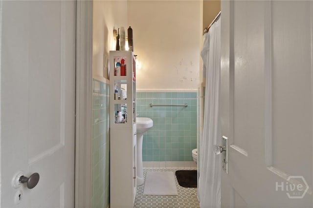 24 E Jones St, Savannah, GA 31401 - full bathroom featuring tile walls, wainscoting, and a shower with shower curtain