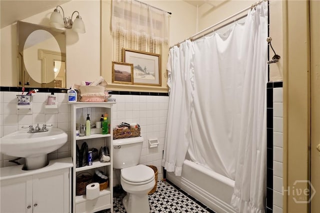 24 E Jones St, Savannah, GA 31401 - full bathroom with tile walls, shower / bath combo with shower curtain, wainscoting, and vanity