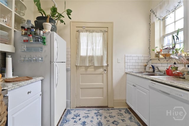 24 E Jones St, Savannah, GA 31401 - kitchen featuring white appliances, healthy amount of natural light, tasteful backsplash, and white cabinetry