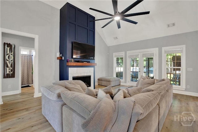 97 Misty Dr, Richmond Hill, GA 31324 - living area with ceiling fan, high vaulted ceiling, a fireplace, light wood-type flooring, and plenty of natural light