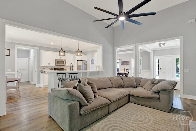 97 Misty Dr, Richmond Hill, GA 31324 - living room featuring crown molding, light wood-type flooring, and ceiling fan