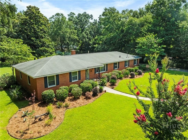 206 Devonshire Rd, Savannah, GA 31410 - ranch-style house with a front yard, brick siding, and a chimney