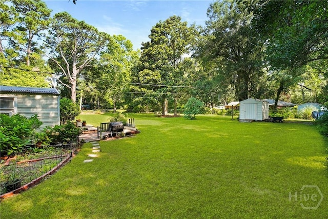 206 Devonshire Rd, Savannah, GA 31410 - view of grassy yard featuring a storage shed and view of scattered trees
