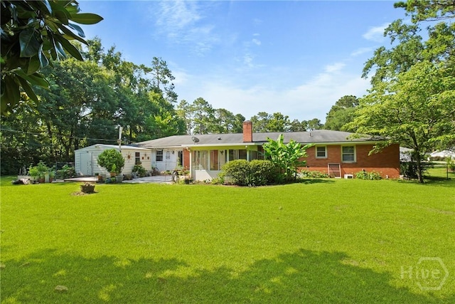 206 Devonshire Rd, Savannah, GA 31410 - back of house with a chimney, a shed, and a yard