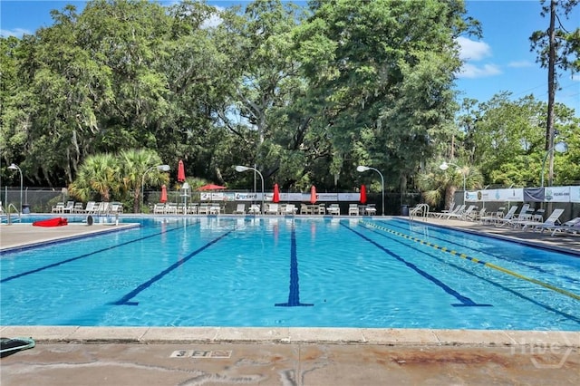 206 Devonshire Rd, Savannah, GA 31410 - community pool with view of wooded area and a patio