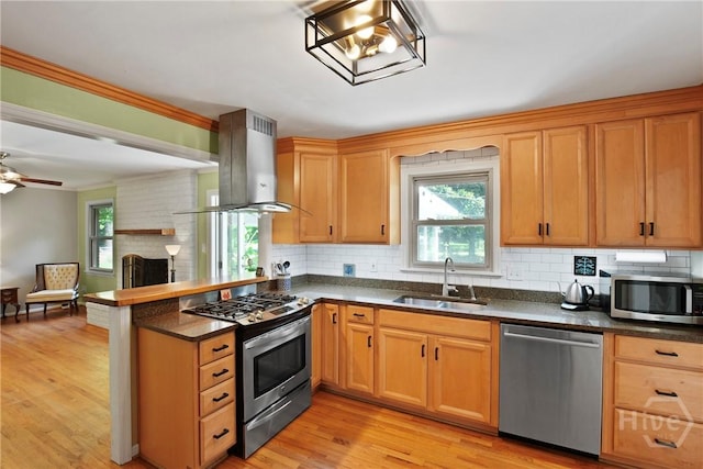 206 Devonshire Rd, Savannah, GA 31410 - kitchen featuring stainless steel appliances, island exhaust hood, a peninsula, and tasteful backsplash