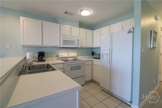 1615 Strand Ave Unit 4, Tybee Island, GA 31328 - kitchen featuring white appliances, white cabinets, light countertops, and light tile patterned flooring