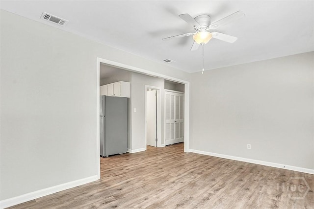 5513 Betty Dr, Savannah, GA 31406 - unfurnished bedroom featuring freestanding refrigerator, light wood finished floors, and a ceiling fan