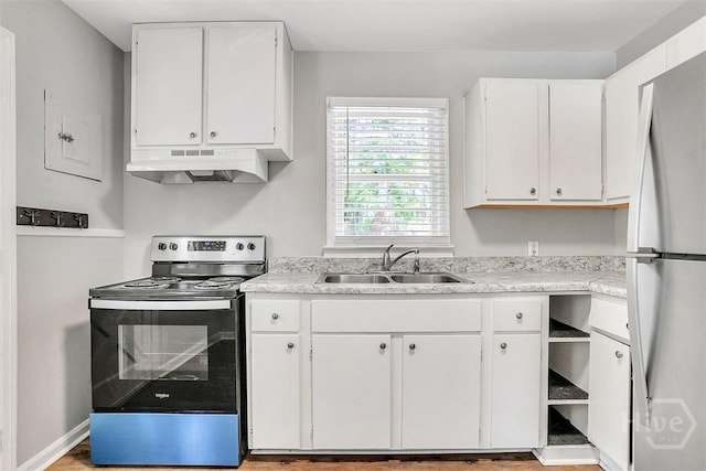 5513 Betty Dr, Savannah, GA 31406 - kitchen featuring under cabinet range hood, stainless steel electric stove, freestanding refrigerator, and light countertops
