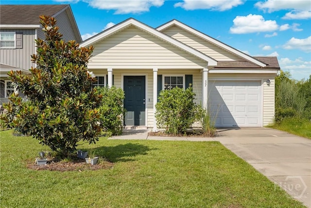 57 Fiore Dr, Savannah, GA 31419 - view of front of home with an attached garage, driveway, a front lawn, and board and batten siding
