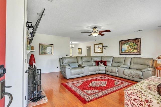 198 Jennifer Cir, Rincon, GA 31326 - living room featuring ceiling fan, wood finished floors, and a textured ceiling