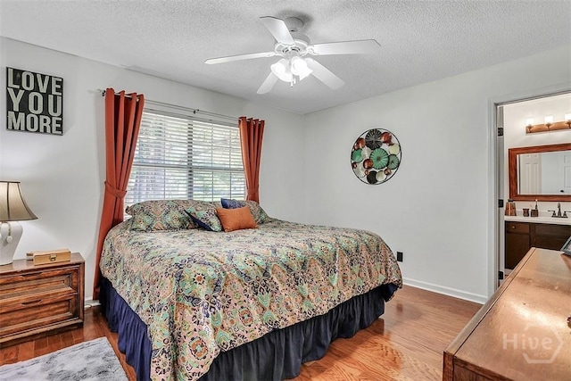 198 Jennifer Cir, Rincon, GA 31326 - bedroom with wood finished floors, a textured ceiling, and a ceiling fan