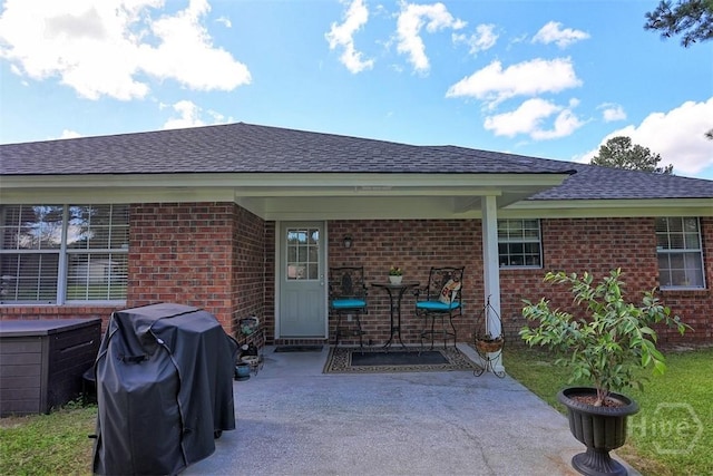 198 Jennifer Cir, Rincon, GA 31326 - back of property featuring brick siding, roof with shingles, and a patio area