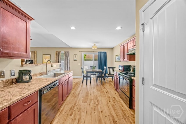 5 Winston Dr, Guyton, GA 31312 - kitchen with black appliances, under cabinet range hood, reddish brown cabinets, light wood-type flooring, and recessed lighting