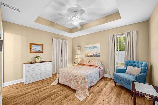 5 Winston Dr, Guyton, GA 31312 - bedroom featuring a raised ceiling, light wood-style floors, and a ceiling fan