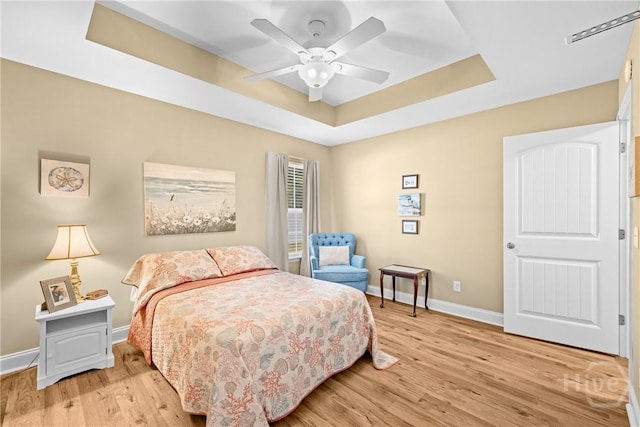 5 Winston Dr, Guyton, GA 31312 - bedroom with a raised ceiling, light wood finished floors, and ceiling fan