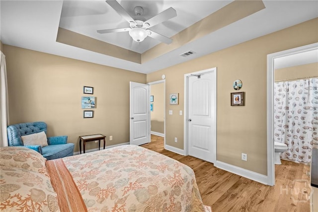 5 Winston Dr, Guyton, GA 31312 - bedroom with a raised ceiling, light wood-style flooring, ceiling fan, and connected bathroom
