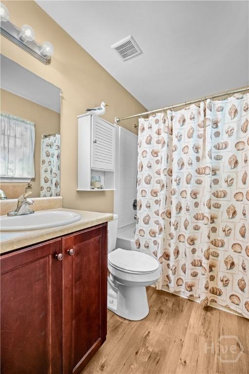 5 Winston Dr, Guyton, GA 31312 - full bath featuring vanity, wood finished floors, and shower / bath combo