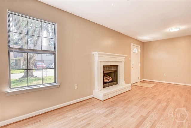117 Fox Chase Rd, Savannah, GA 31406 - unfurnished living room with light wood-style flooring and a fireplace