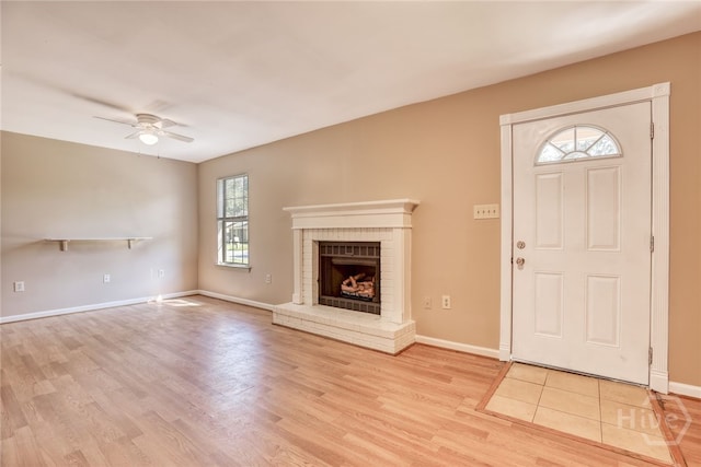 117 Fox Chase Rd, Savannah, GA 31406 - unfurnished living room with light wood finished floors, ceiling fan, and a brick fireplace