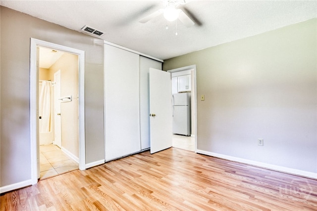 117 Fox Chase Rd, Savannah, GA 31406 - unfurnished bedroom with freestanding refrigerator, light wood-style flooring, a ceiling fan, a closet, and ensuite bath