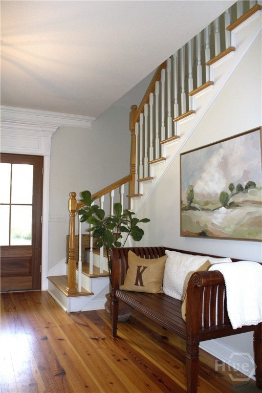 2766 Fort Mcallister Rd, Richmond Hill, GA 31324 - entryway with wood finished floors, stairs, and ornamental molding