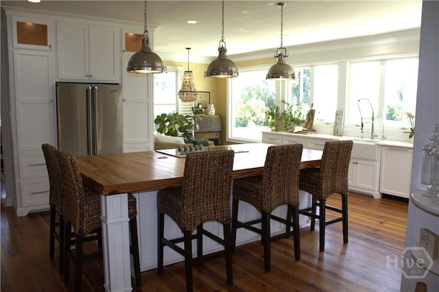 2766 Fort Mcallister Rd, Richmond Hill, GA 31324 - kitchen with high end fridge, white cabinetry, dark wood-type flooring, decorative light fixtures, and recessed lighting