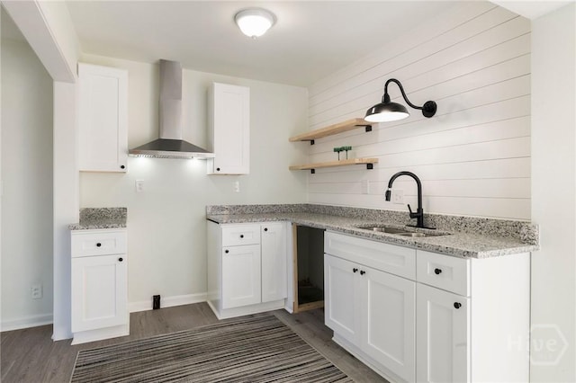 1321/1323 E 55th St, Savannah, GA 31404 - kitchen with wall chimney range hood, wood finished floors, white cabinetry, light stone counters, and open shelves
