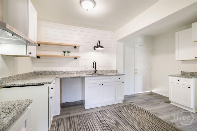 1321/1323 E 55th St, Savannah, GA 31404 - kitchen with open shelves, light wood-style floors, white cabinetry, and light stone countertops